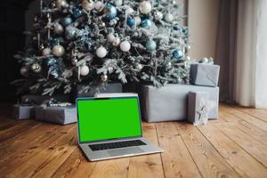 laptop with green screen - chromakey near New Year's decorations. christmas theme. photo