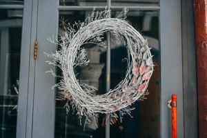 Christmas wreath hanging on the glass door in cafe photo