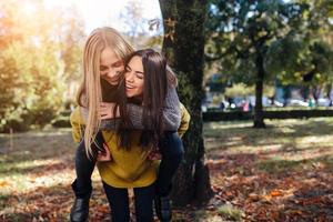 Two girls having fun in the park photo