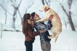 Young couple having fun in winter park photo