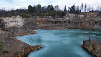Beautiful quarry, the lake is covered with thin ice photo