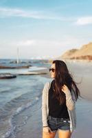 Young beautiful girl posing by the sea photo