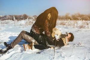 Young couple having fun in winter park photo