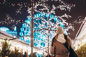 Girl posing against the background of decorated trees photo