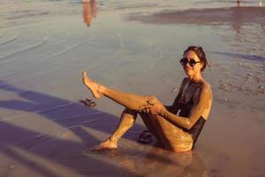 A young woman enjoying the natural mineral mud photo