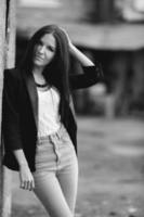 Beautiful female model posing against the wall photo