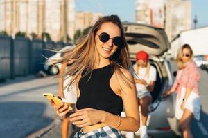 Beautiful young girl in sunglasses posing for the camera. photo