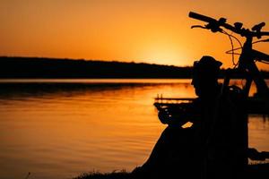 The guy rests on the river bank. photo