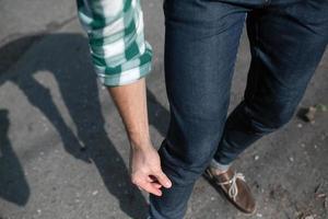 Feet of the man in the authentic boots and  selvedge jeans photo