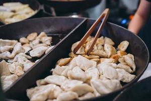 Dumplings with meat, onions on a big cast iron skillet. photo