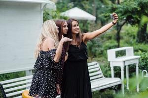 Three girls make selfies photo