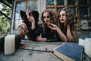 Three vintage witches perform magic ritual photo