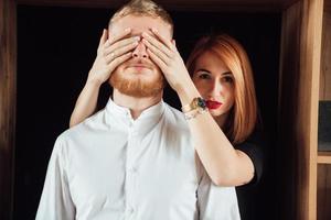 Close up of woman covering boyriends eyes with hands. photo