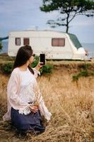 Beautiful, young girl posing on a wild seashore photo