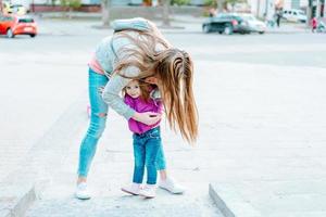 Mom and girl playing, having fun photo