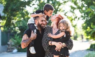 Mom, Dad, little son and daughter have fun photo