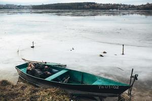 man and woman lie in the boat photo