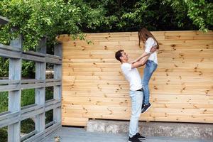 couple posing on a background of the wooden wall photo