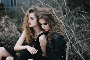 Two vintage witches gathered eve of Halloween photo