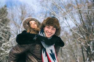 man carries a girl on his back photo