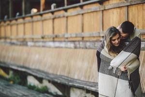 Young couple wrapped in plaid photo