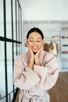 Portrait of a beautiful healthy woman in bathrobe indoors photo
