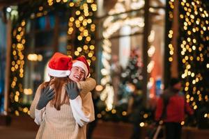 Portrait of happy cute young friends hugging each other photo