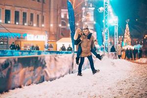 Cheerful and playful couple in warm winter outfits are fooling around photo