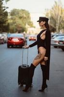 A young sexy woman in a black leotard posing on a camera photo