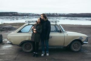 young beautiful couple on the ice of a frozen lake photo