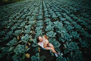 Mother and daughter on the field with cabbage photo