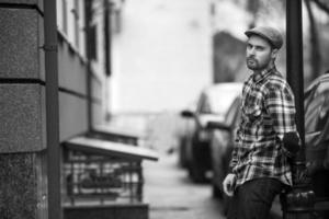 The man in the authentic boots and selvedge jeans  on a background of old city photo