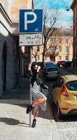 Beautiful fashionable lady posing on old street photo