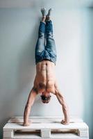 Man posing on camera, standing upside down photo