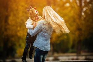 Mother with daughter in autumn park photo