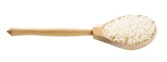 spoon with polished medium-grain rice isolated photo