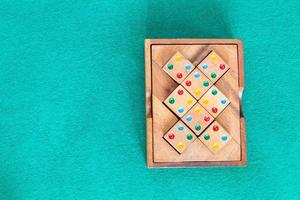 top view of wooden box with puzzle on green table photo