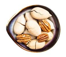 cracked and shelled pecan nuts in bowl isolated photo