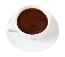 above view of hot carob powder drink in white cup photo