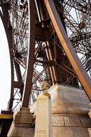 bust of Eiffel near tower photo