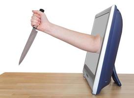 female hand with kitchen knife leans out TV screen photo