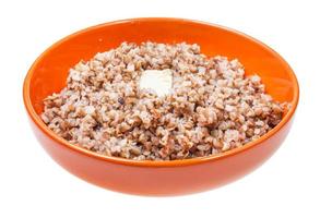 buckwheat porridge with piece of butter in bowl photo