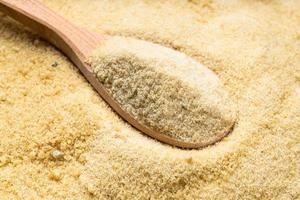 wooden spoon with granulated coconut sugar photo