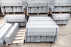 stockpiles of new gray concrete curbs photo