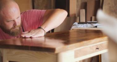 Master Carpenter checks the quality of the oil finish, countertops video