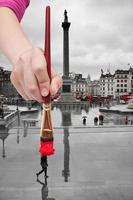 paintbrush paints red umbrella in London photo