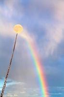 full moon tied on chain soars on rainbow photo