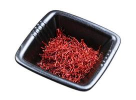 crocus saffron threads in black bowl isolated photo