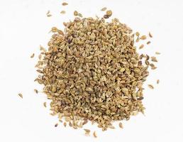 top view of pile of Ajwain seeds close up on gray photo