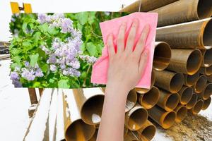 hand deletes industrial landscape by pink cloth photo